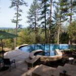 outdoors pool and hot tub in the middle of the woods